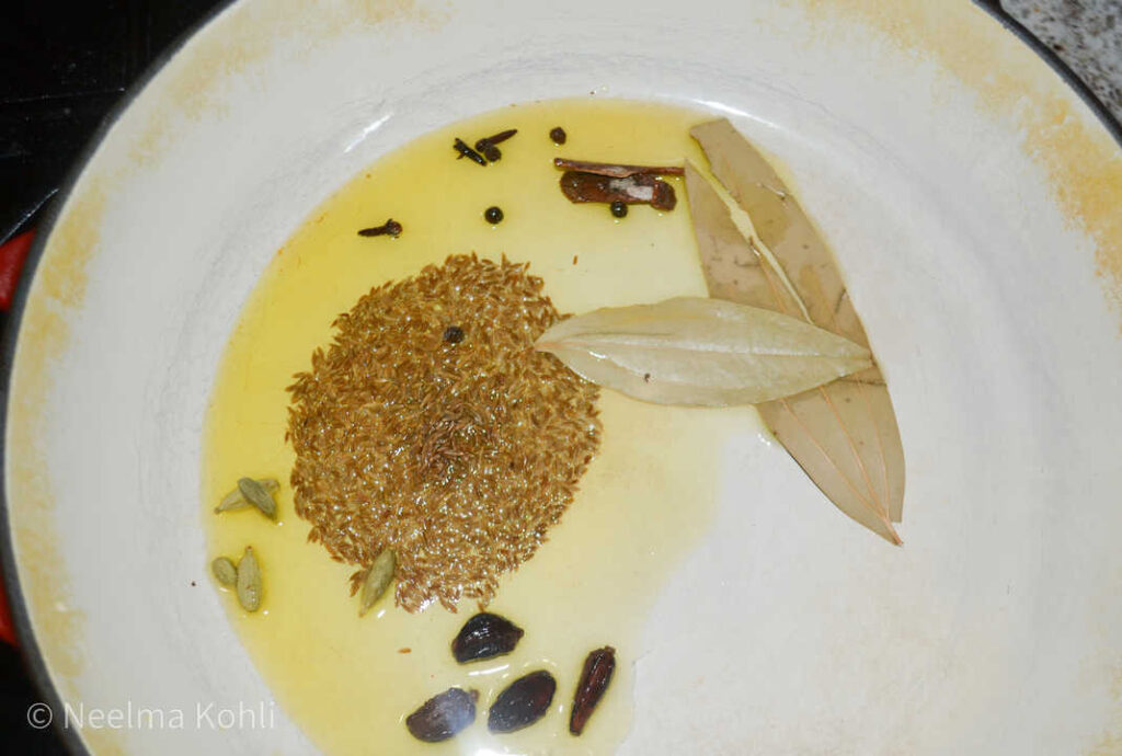 Ghee with whole spices for biryani